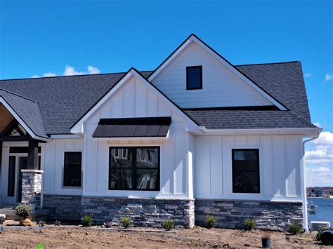 houses with black metal roof|house with black metal accents.